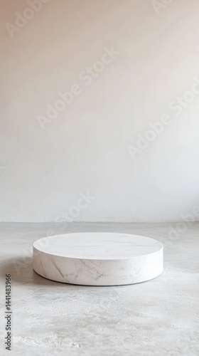 Obraz na płótnie Minimalist marble podium on concrete floor against a plain wall backdrop in soft natural light studio shot for product display and promotion with neutral background w salonie