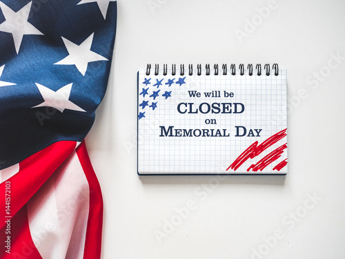 We will be closed on Memorial Day. American Flag and sign board with the inscription. Closeup, no people. Congratulations for family, relatives, friends, colleagues