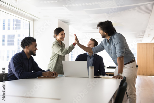 Happy Indian teammates giving high five gesture, express appreciation, gratitude for successful joint project completion, start-up launch, showing amity and friendly relation. Gender equality, respect