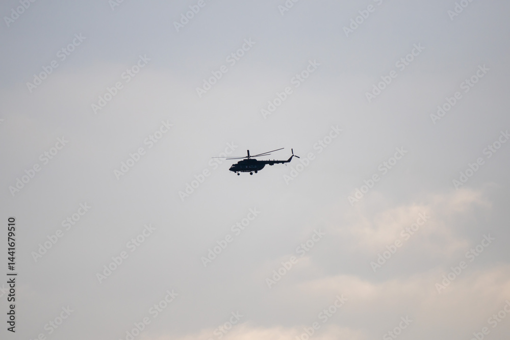 A helicopter is flying in the sky A helicopter is flying in the sky