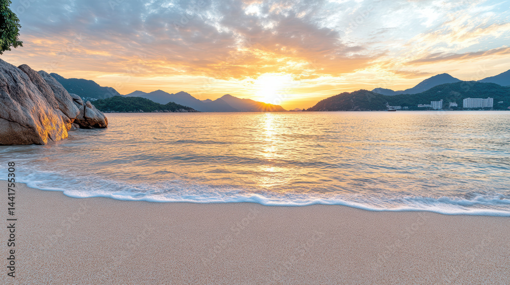 Fototapeta premium Golden sunset over tranquil beach with gentle waves lapping at shore