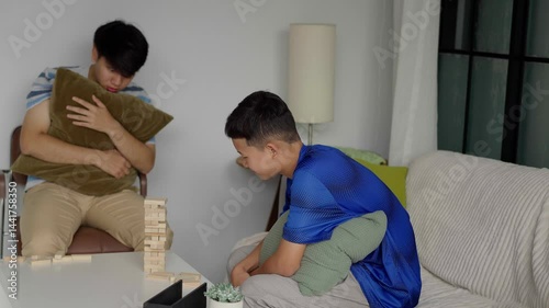 Brother and younger brother play board games together.