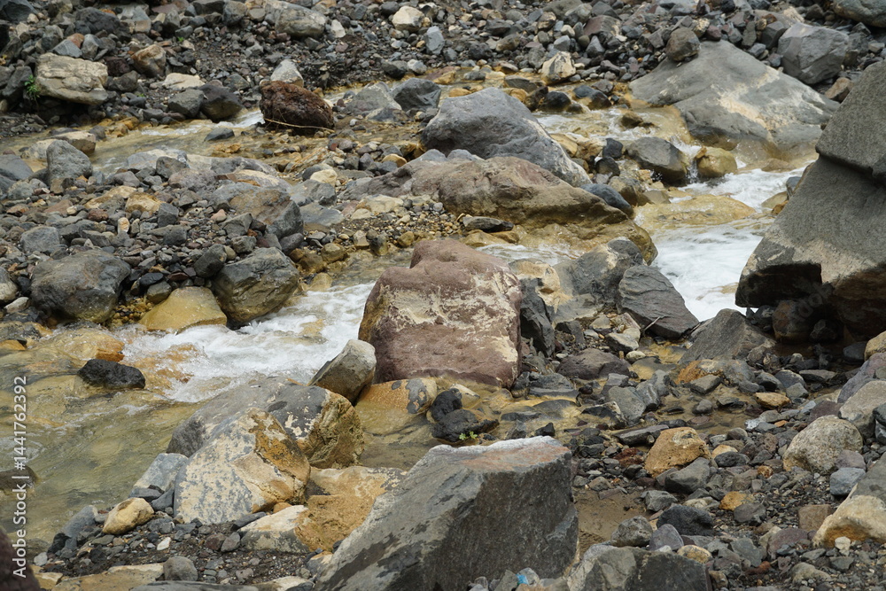 Nature's tranquil stream flowing through rocky terrain landscape wilderness close-up serenity Nature's tranquil stream flowing through rocky terrain landscape wilderness close-up serenity