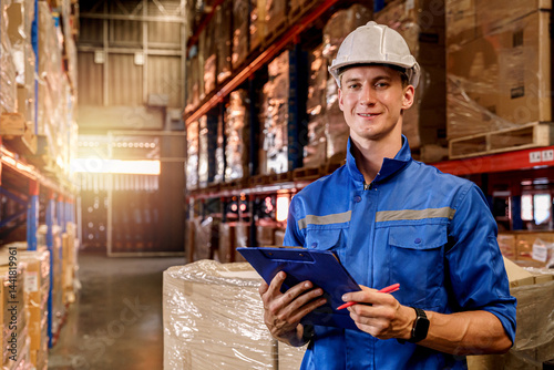 A warehouse worker doing inventory inspection on a clipboard in a storage warehouse.