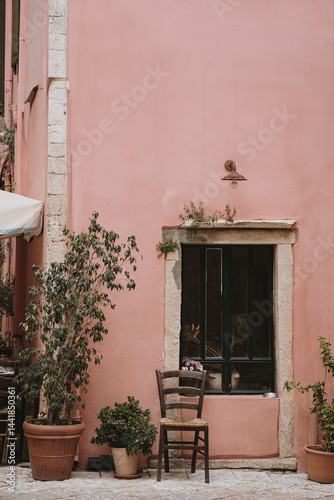 Fototapeta Naklejka Na Ścianę i Meble -  Charming Outdoor Seating by Pink Wall