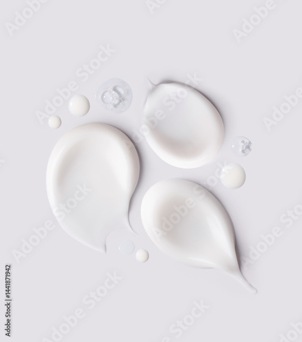 samples of cosmetic care products smear of cream and gel texture on a light background