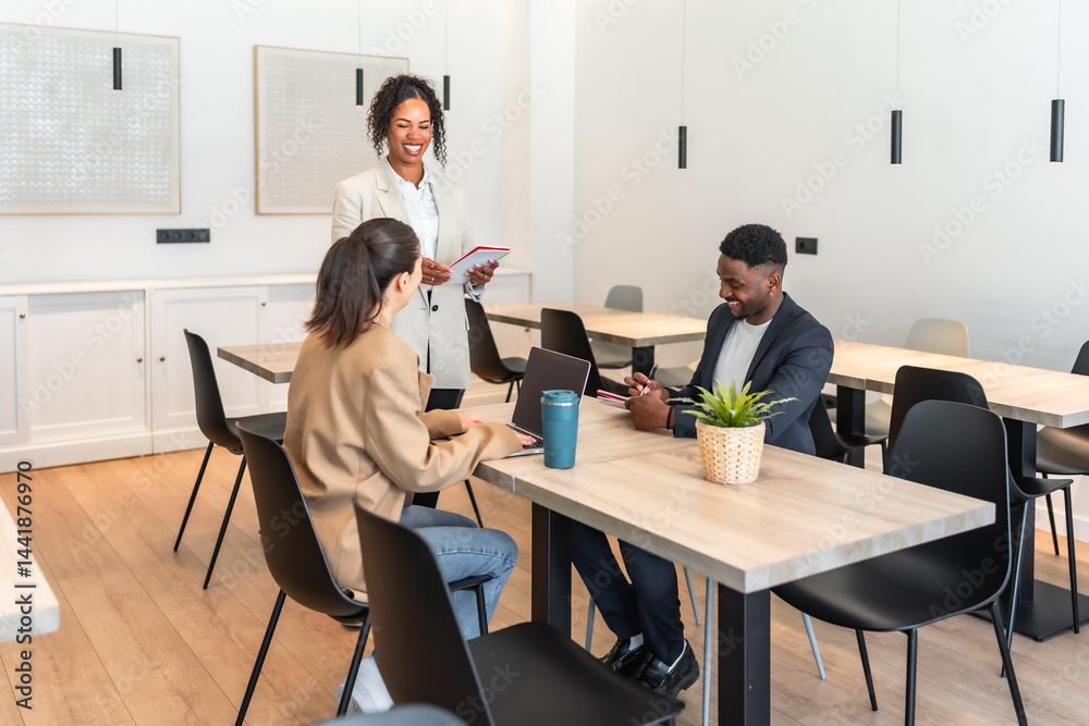 Business team discussing strategy in modern office cafeteria