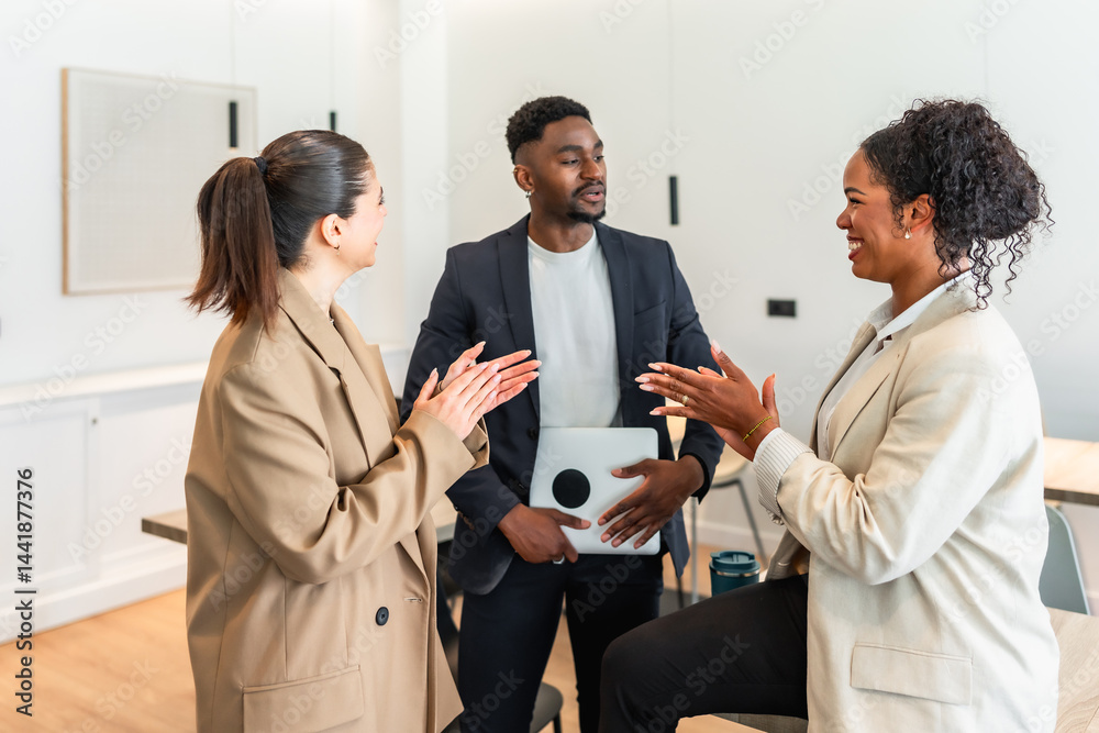 Business people clapping and talking during a meeting