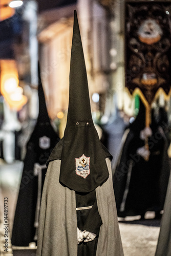 Hooded brothers with conical hats that serve as masks, Holy Week procession, Llucmajor, Mallorca, Balearic Islands, Spain