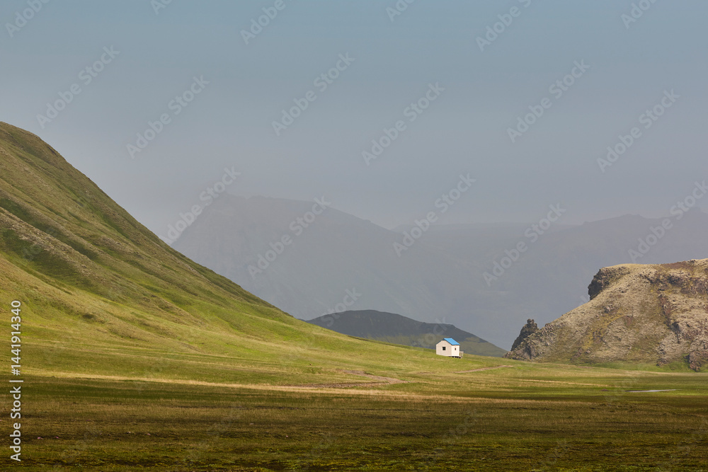 Picturesque shelter in a green misty landscape. Icelandic loneliness scenery