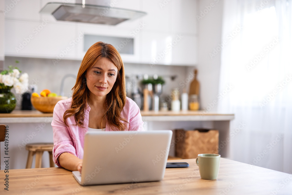 Beautiful woman freelancer noting information for planning project doing remote job via laptop computer. woman reading email on modern laptop device Beautiful woman freelancer noting information for planning project doing remote job via laptop computer. woman reading email on modern laptop device