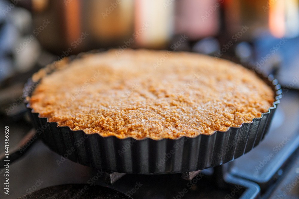 Cake with almond crust and creamy interior in a steel baking tin. An old German recipe for