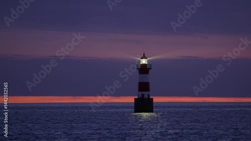 Wallpaper Mural A tall lighthouse endures powerful ocean waves battering its base during twilight
 Torontodigital.ca