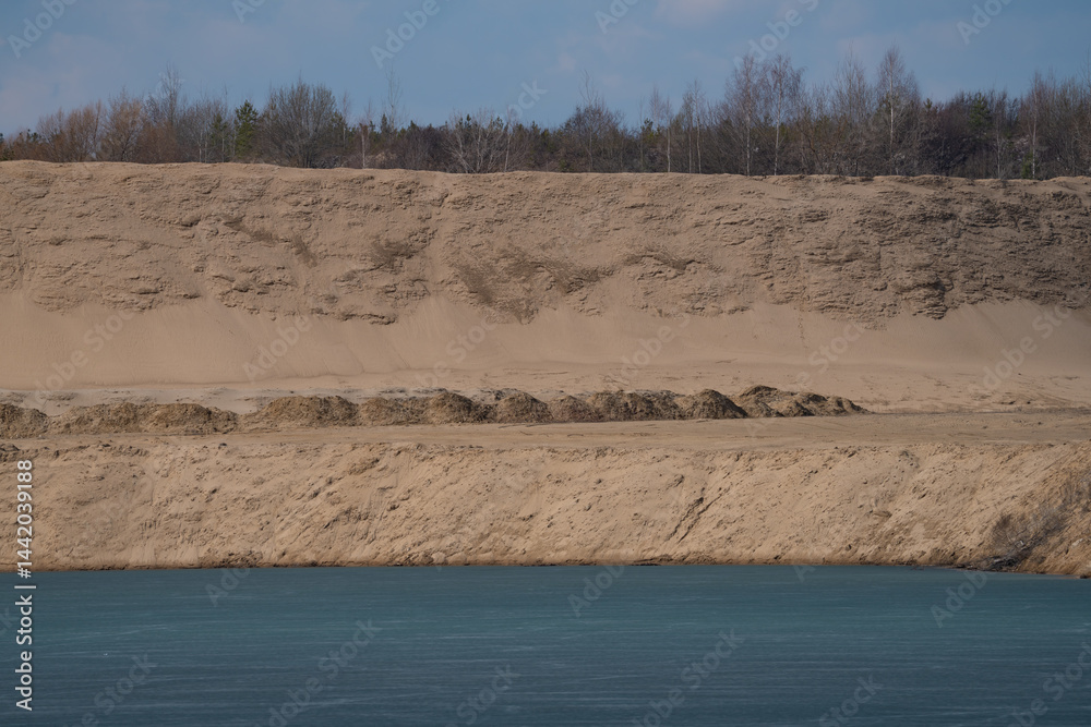sandy lake shore with pine forest, spring landscape