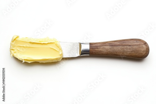 Creamy butter spread on a wooden handled knife perfect for baking or bread white background