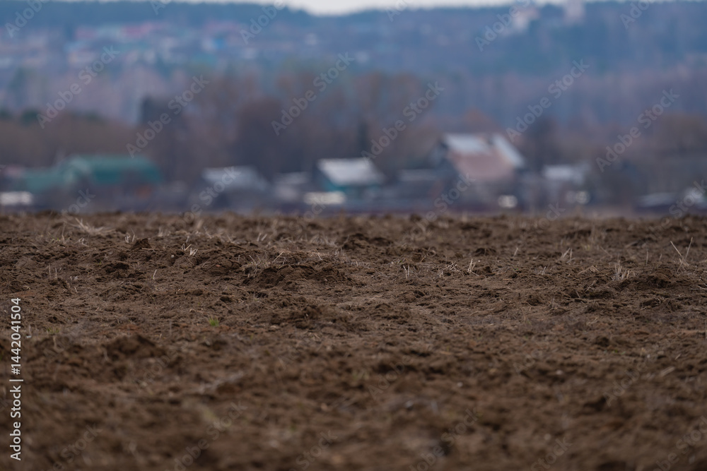 a plowed agricultural field , a spring landscape in the countryside