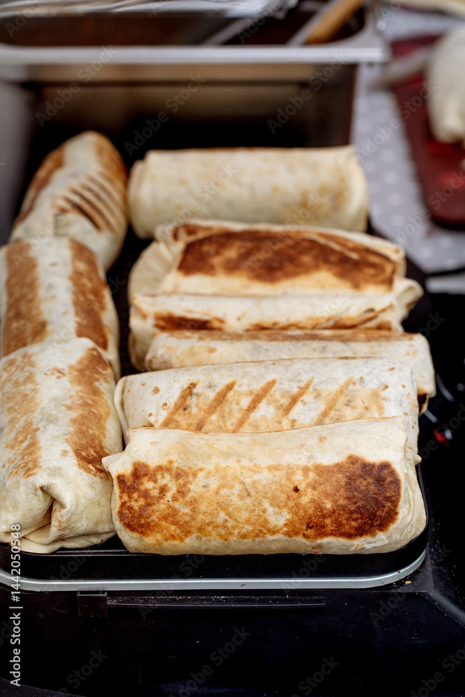 Grilled Burritos on Cooking Surface Grilled Burritos on Cooking Surface