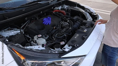 Girl woman hands opening car hood completely