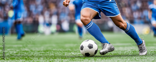Close-up of a Leg in a Boot Kicking Football Ball. Professional Soccer Player Hits with Fierce Power, Scores Goal, Grass Flying. Football Championship Concept. Low Angle Ground Artistic Shot.