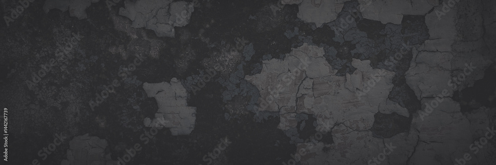 Dark wide panoramic background. Peeling paint on a concrete wall. Faded dark texture of old cracked flaking paint. Weathered rough painted surface with patterns of cracks. Shaded background for design