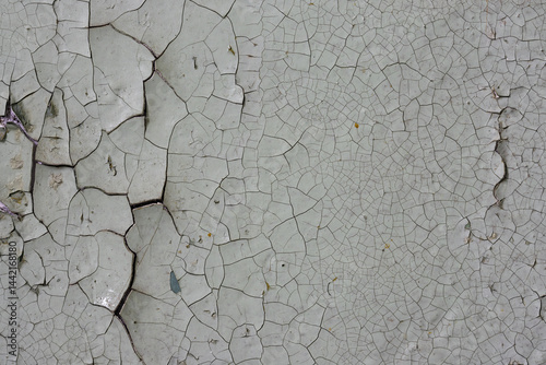 Obraz na płótnie Peeling paint on the wall. Old concrete wall with cracked flaking paint. Weathered rough painted surface with patterns of cracks and peeling. High resolution texture for background and design. Closeup w salonie