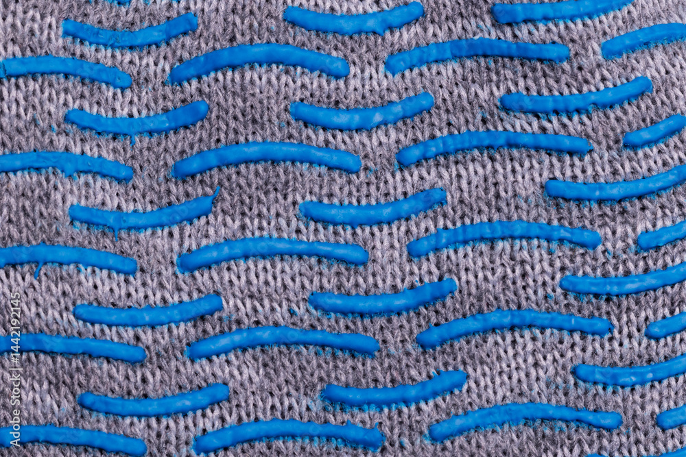 Close-up of textured fabric with blue rubber grip pattern Close-up of textured fabric with blue rubber grip pattern