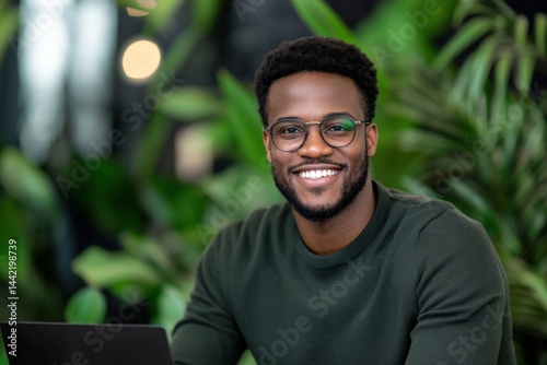 Smiling man near laptop