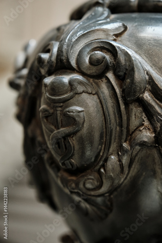 Close-up of an Ornate Metal Caduceus Emblem. Macro photograph emphasizing the intricate design of the traditional medical symbol.