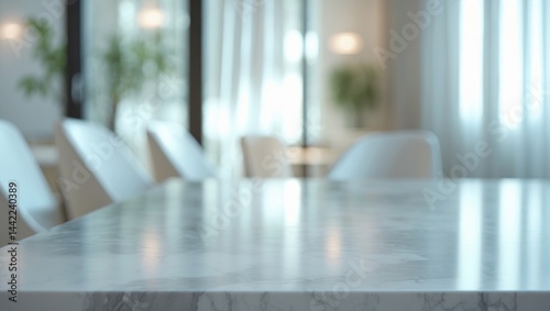 Clear white marble stone table top with a blurred glass window in an interior cafe and restaurant setting - perfect for product display or montage.
