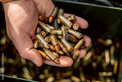 full metal jacket ammunition held in a hand. many cartridges for the machine gun in the hand