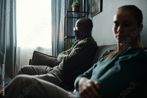 Husband and Wife Sitting with Arms Crossed At Psychologists