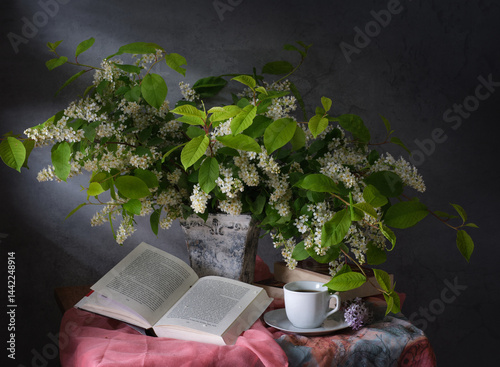 Obraz na płótnie The Serene Still Life features a Book, fragrant Tea, and vibrant Flowers in harmony w salonie