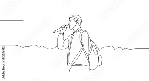 Young man singing into microphone against simple background  