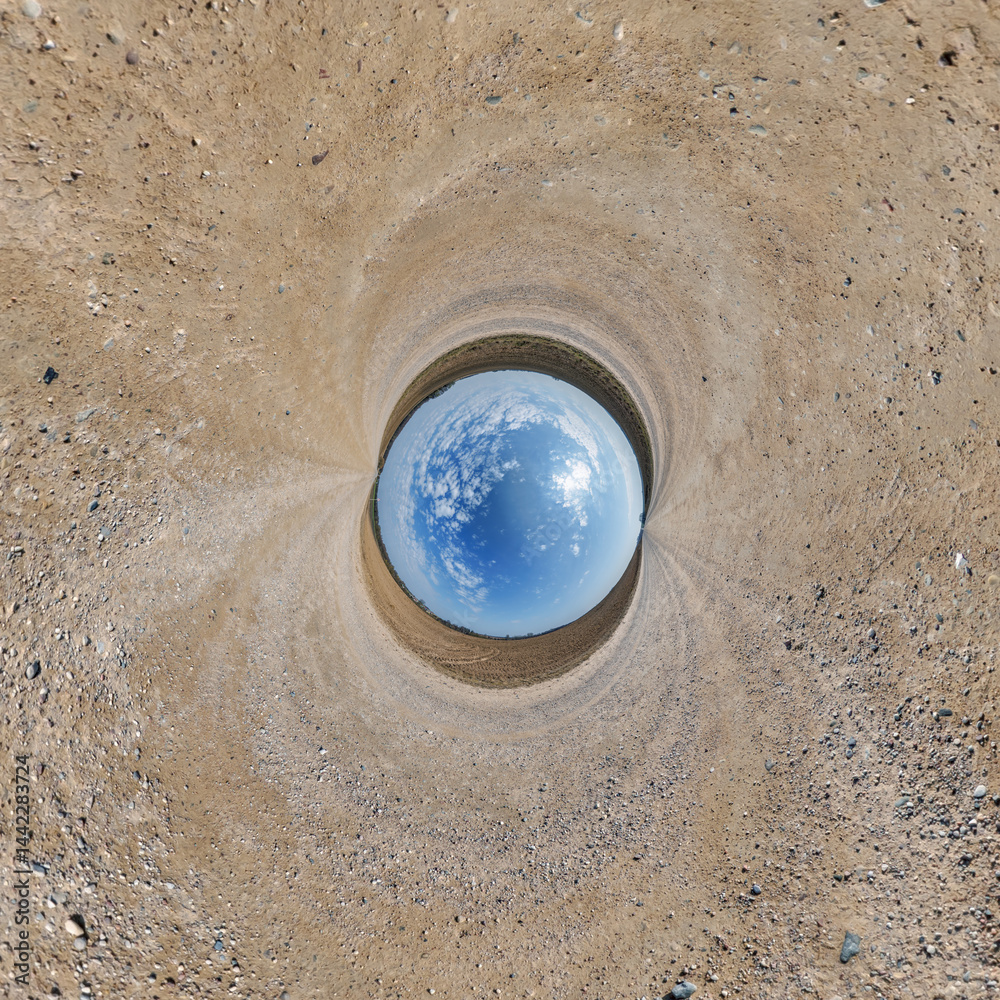 blue hole sphere or globe little planet inside grass or sand or dry ground frame background with tractor tracks