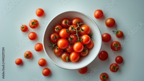 Healthy fresh cherry tomatoes presented in a white bowl. Isolated setting. photo