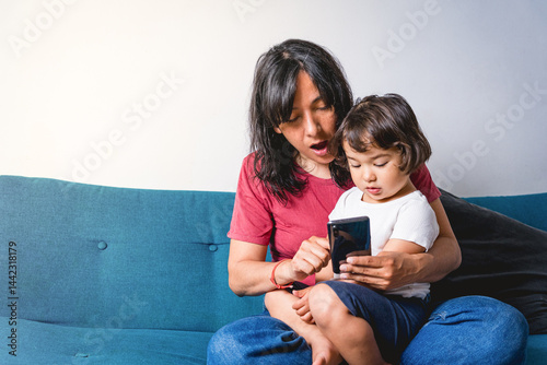 Baby toddler and mother looking together at tablet, checking children content in social media. Concept of screen addiction and social media addiction in children, parenting and technology