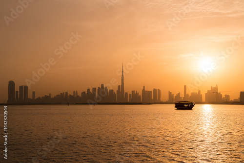 sunset over the city of dubai with a boat