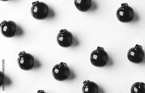 Obraz na płótnie Flat lay of black blueberries arranged in a repeating pattern on a white background. w salonie