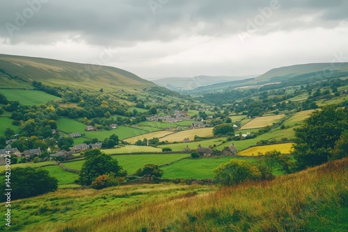 Rolling Green Hills and Farmland with Distant Village Under Cloudy Sky