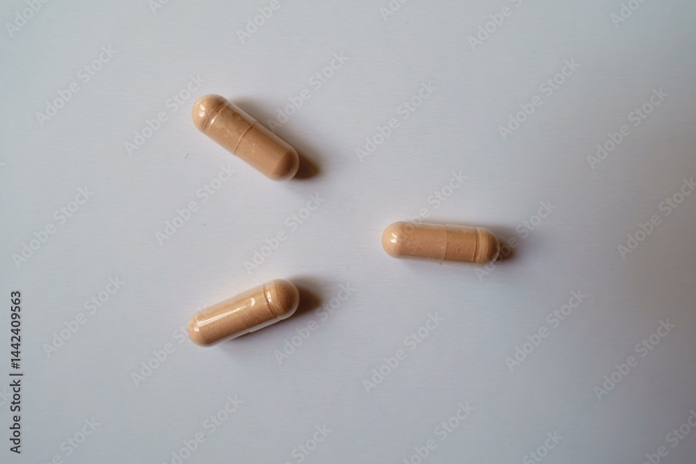 3 pink capsules of palmitoylethanolamide dietary supplement from above