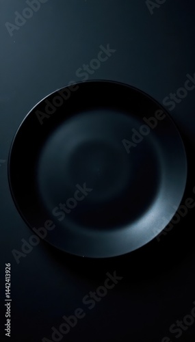 Empty black plate, dark moody backdrop, overhead view, clean, round