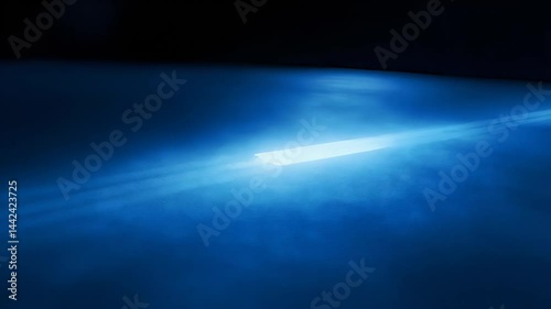 Soft blue light dances across a dark surface, creating mesmerizing patterns. The ambient glow highlights shapes and contours, evoking a magical nighttime ambiance