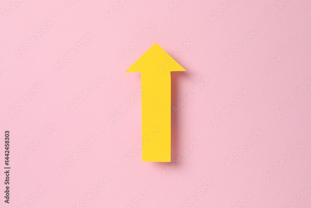 Paper arrow on color background, top view Paper arrow on color background, top view