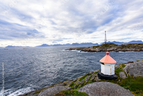Obraz na płótnie A scenic view of Henningsvær in Lofoten Islands, northern Norway, showcasing traditional buildings along the harbor with mountains in the background. w salonie