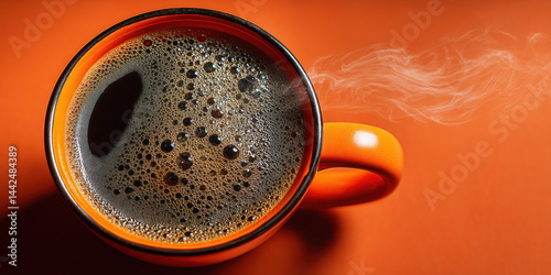 An engaging representation of hot coffee in orange cup on orange tabletop, ideal for creative, commercial, or editorial purposes.