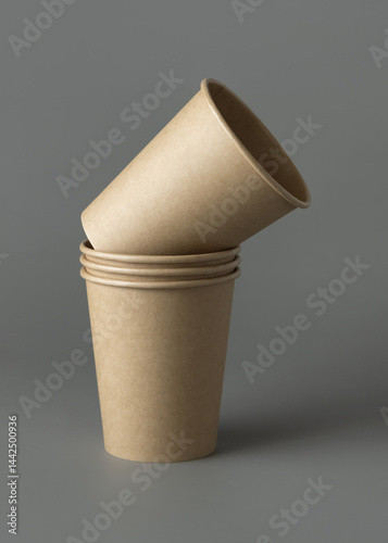 Obraz na płótnie Disposable beige kraft paper cups on a gray closeup, mockup. No plastic and sustainable lifestyle w salonie