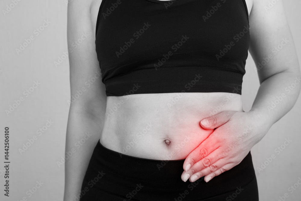Girl holding her left side of her body in pain.