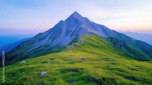 Majestic mountain peak at dawn, lush green alpine meadow