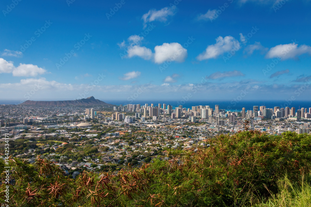 Panorama cityscape of Honolulu, Oahu, Hawaii, USA seen from viewpoint along Round Top Drive against blue sky with clouds