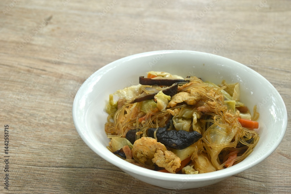 fried glass noodles slice pork and cabbage with egg on bowl